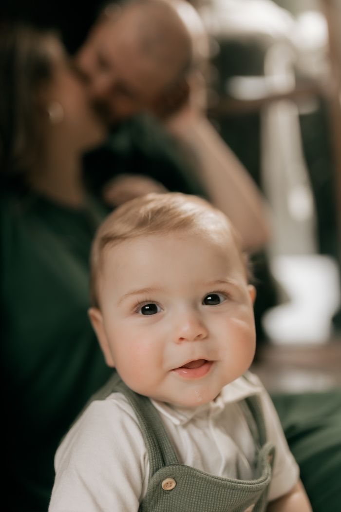 services-03 Cute baby with family in cozy indoor setting, showcasing warmth and happiness.